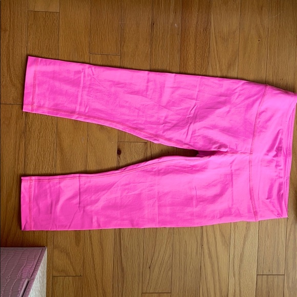 Neon pink Lululemon cropped leggings.